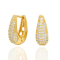Gold pavé huggie earrings with sculptural glow. Lightweight, hypoallergenic, and elegant - for modern glam with a festive spark by DrammaⓇ.
