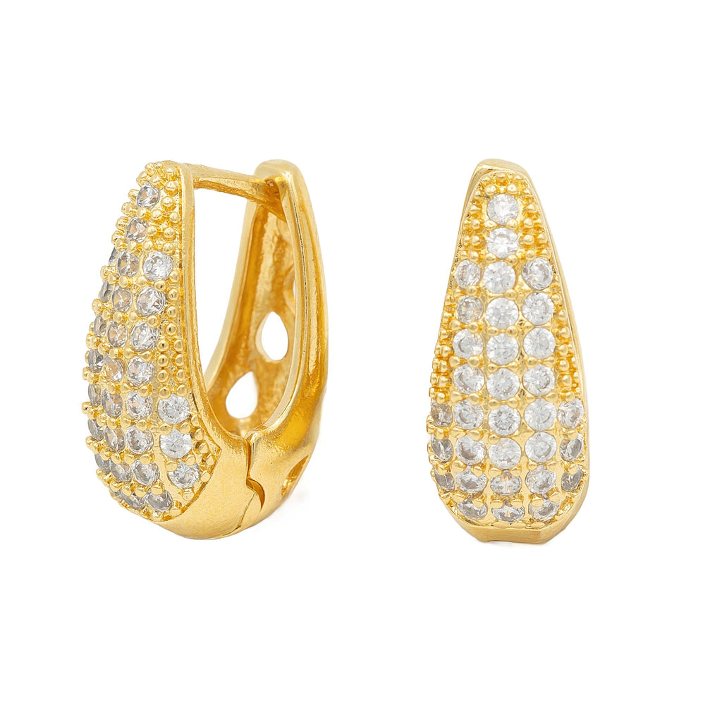 Gold pavé huggie earrings with sculptural glow. Lightweight, hypoallergenic, and elegant - for modern glam with a festive spark by DrammaⓇ.
