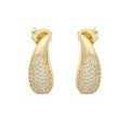 Comma-shaped pavé earrings in gold. Sculptural, lightweight, hypoallergenic. Statement sparkle with wit and elegance by DrammaⓇ.