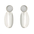Silver-tone sculptural drop earrings with fluid, elongated shape. Bold, reflective, and architecturally expressive by Dramma®.


