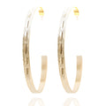 Gold hoop earrings with matte texture and engraved line. Lightweight, sculptural, and hypoallergenic — refined everyday elegance by Dramma®.