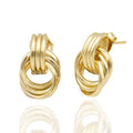 Polished gold stud earrings with interlocking hoops. Lightweight, sculptural, and hypoallergenic — refined modern design by Dramma®.