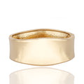 Gold-tone sculptural cuff bracelet with clean linear design. Reflective, architectural, and powerfully elegant by Dramma®.