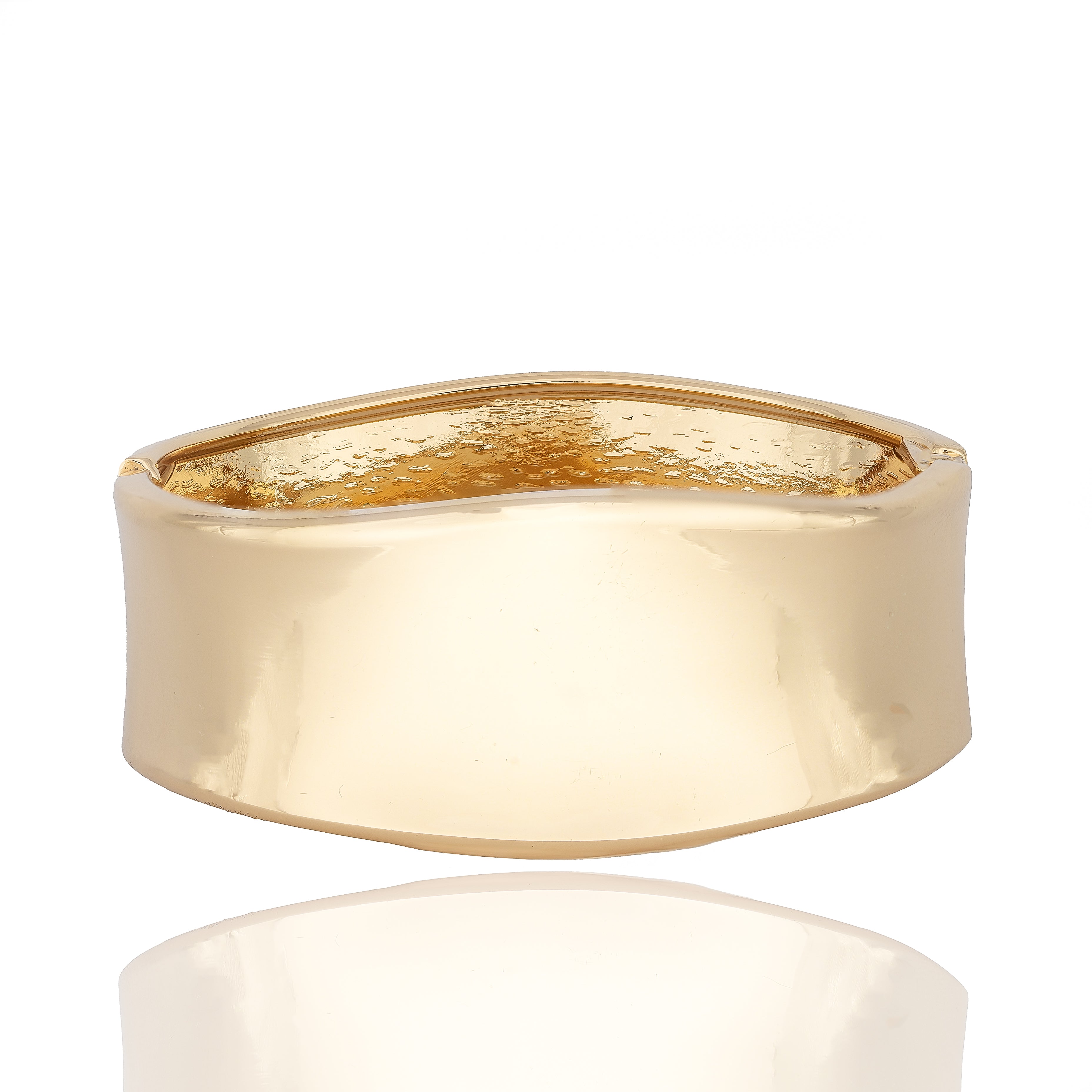 Gold-tone sculptural cuff bracelet with clean linear design. Reflective, architectural, and powerfully elegant by Dramma®.
