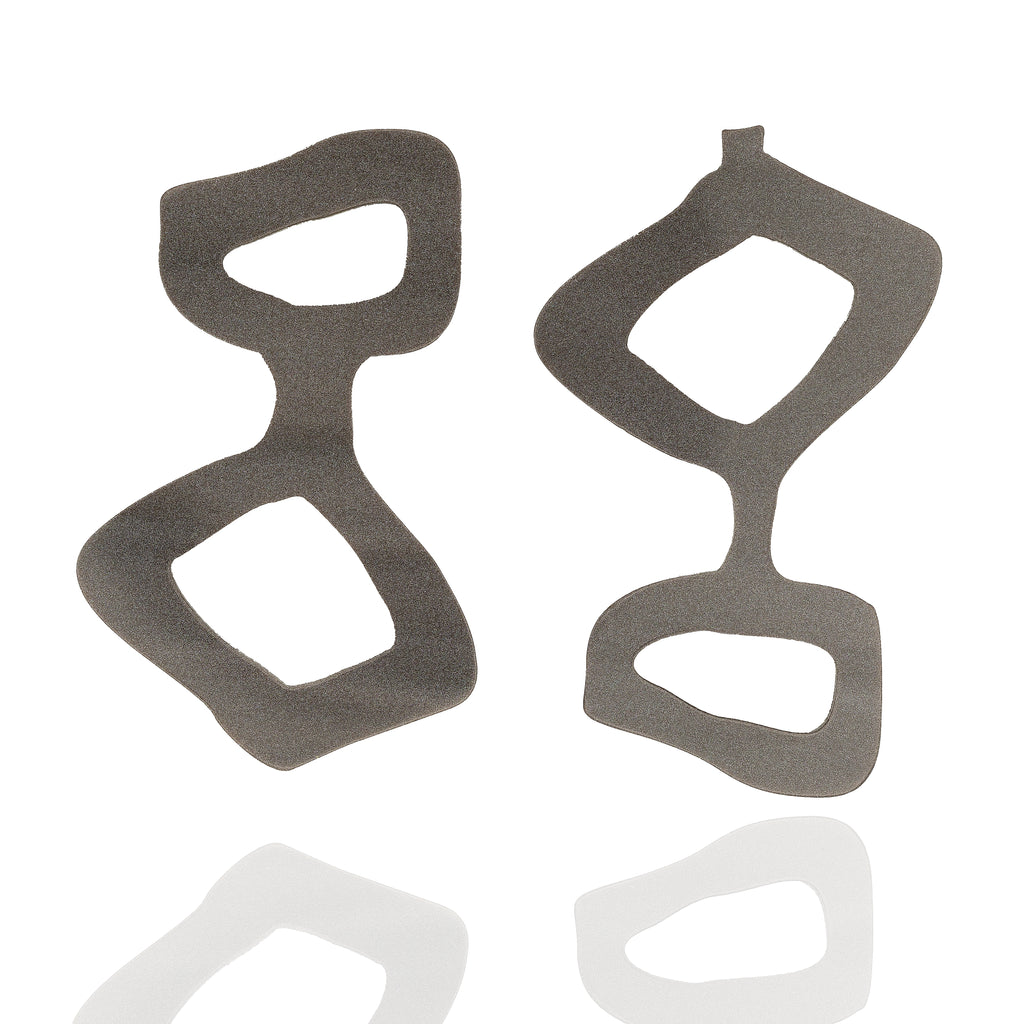 Handmade acrylic statement earrings in graphite gray. Lightweight, graphic, and hypoallergenic — wearable art by Dramma®.
