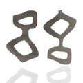 Handmade acrylic statement earrings in graphite gray. Lightweight, graphic, and hypoallergenic — wearable art by Dramma®.
