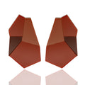 Acrylic sculptural drop earrings in red and terracotta. Lightweight, bold, and hypoallergenic — handmade geometric design