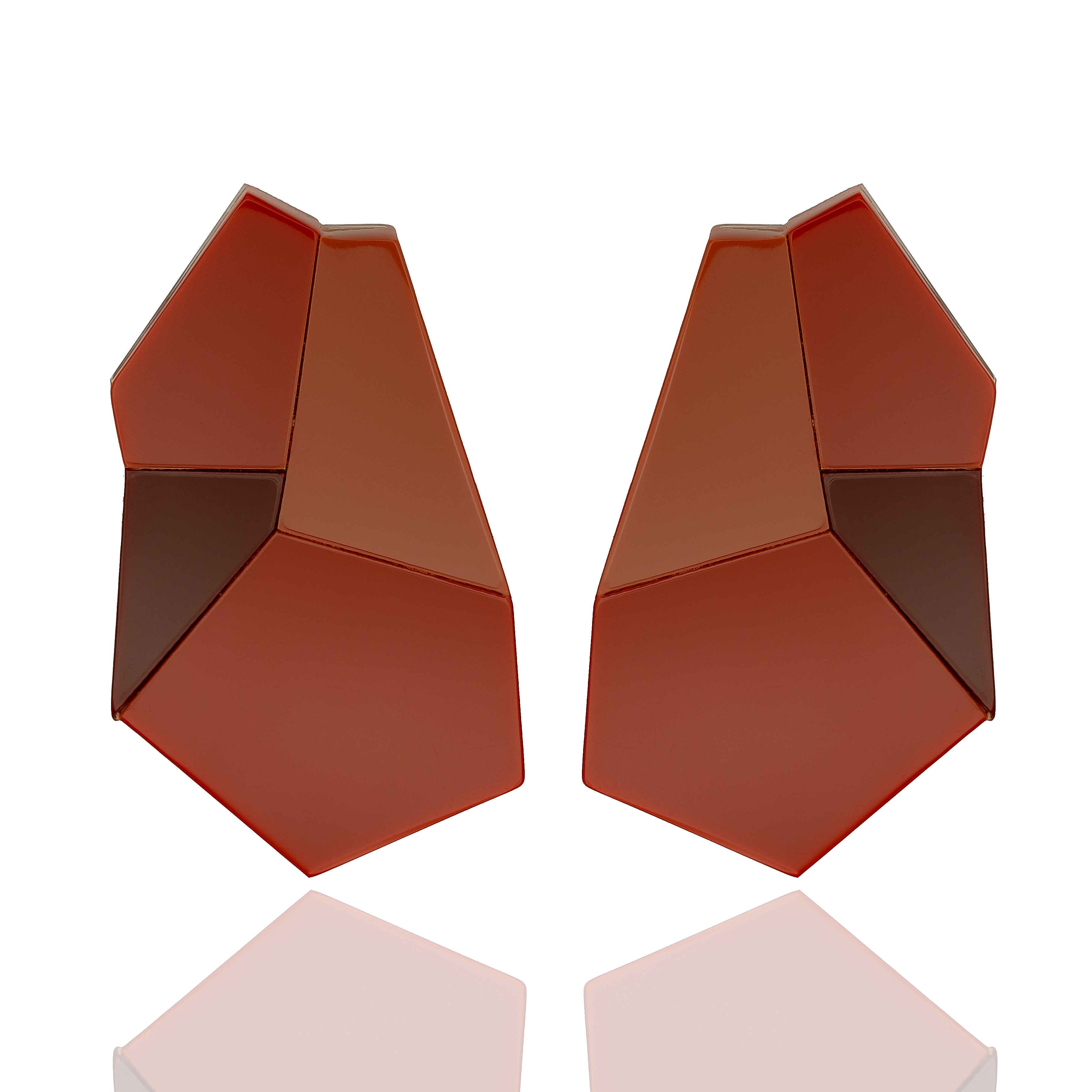 Acrylic sculptural drop earrings in red and terracotta. Lightweight, bold, and hypoallergenic — handmade geometric design