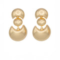 Orbit earrings in polished gold tone with sculptural volume. Lightweight, reflective, and designed with clean modern geometry by Dramma®.
