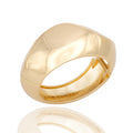 Gold-tone sculptural cuff bracelet with bold curved form. Reflective, architectural, and powerfully expressive by Dramma®.