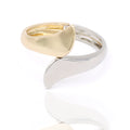 Gold and silver-tone sculptural cuff bracelet with fluid, architectural form. Reflective, bold, and artfully modern by Dramma®.
