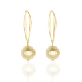 Gold dangle earrings with suspended sphere design. Lightweight, architectural, and hypoallergenic — quiet statement elegance by Dramma®.