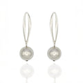 Silver dangle earrings with suspended orb design. Lightweight, sculptural, and hypoallergenic — minimalist elegance by Dramma®.
