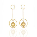 Gold dangle earrings with concentric rings and floating orb. Lightweight, hypoallergenic, and balanced — refined modern art by Dramma®
