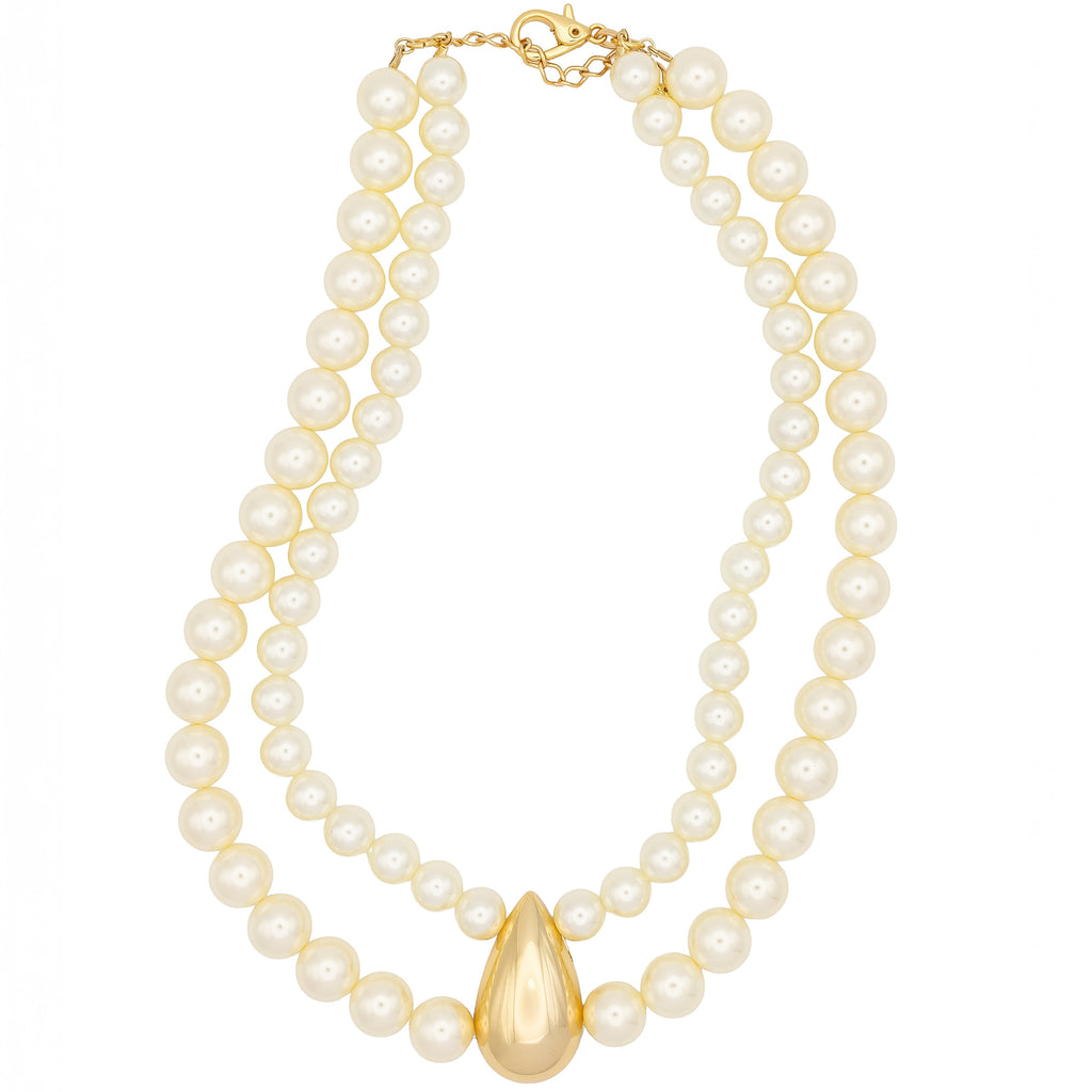 Layered pearl necklace with sculptural gold drop. Elegant, bold, and handcrafted. For timeless drama with modern attitude by DrammaⓇ.
