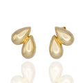 Sculptural gold teardrop studs from DRAMMA®. Small, lightweight, and hypoallergenic — refined everyday elegance with artistic presence.
